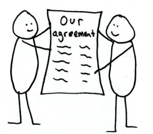 Two people holding a contract that reads "our agreement".